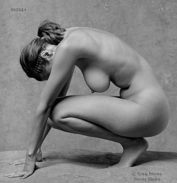 Nude woman crouched in studio, profile, Natalie b&w photo by Craig Morey